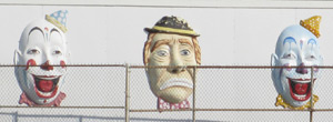 smiling clown faces on the side of buildings on the Casino Pier