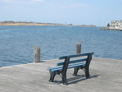 two empty benches along the shore of the bay